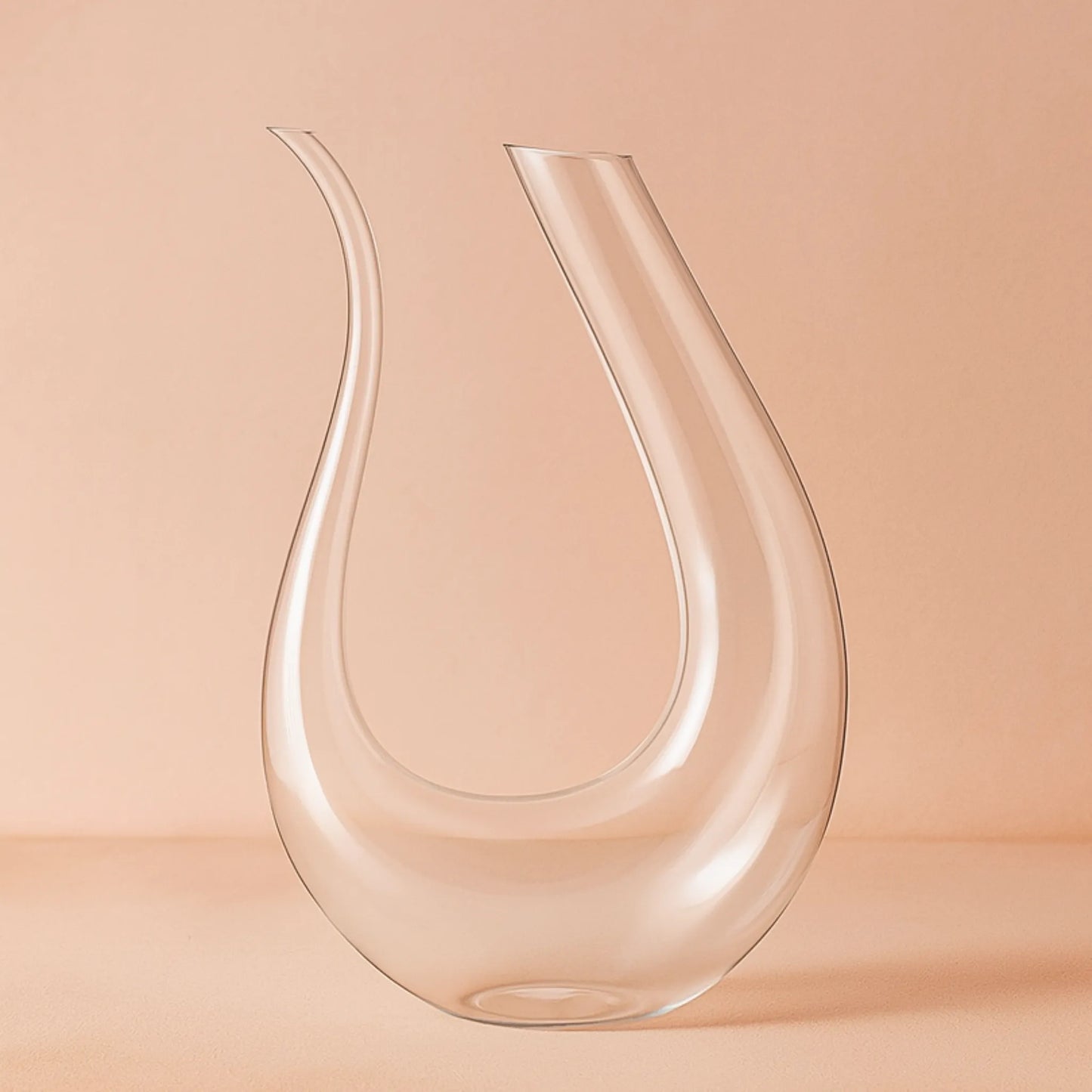 Clear glass carafe on a peach background