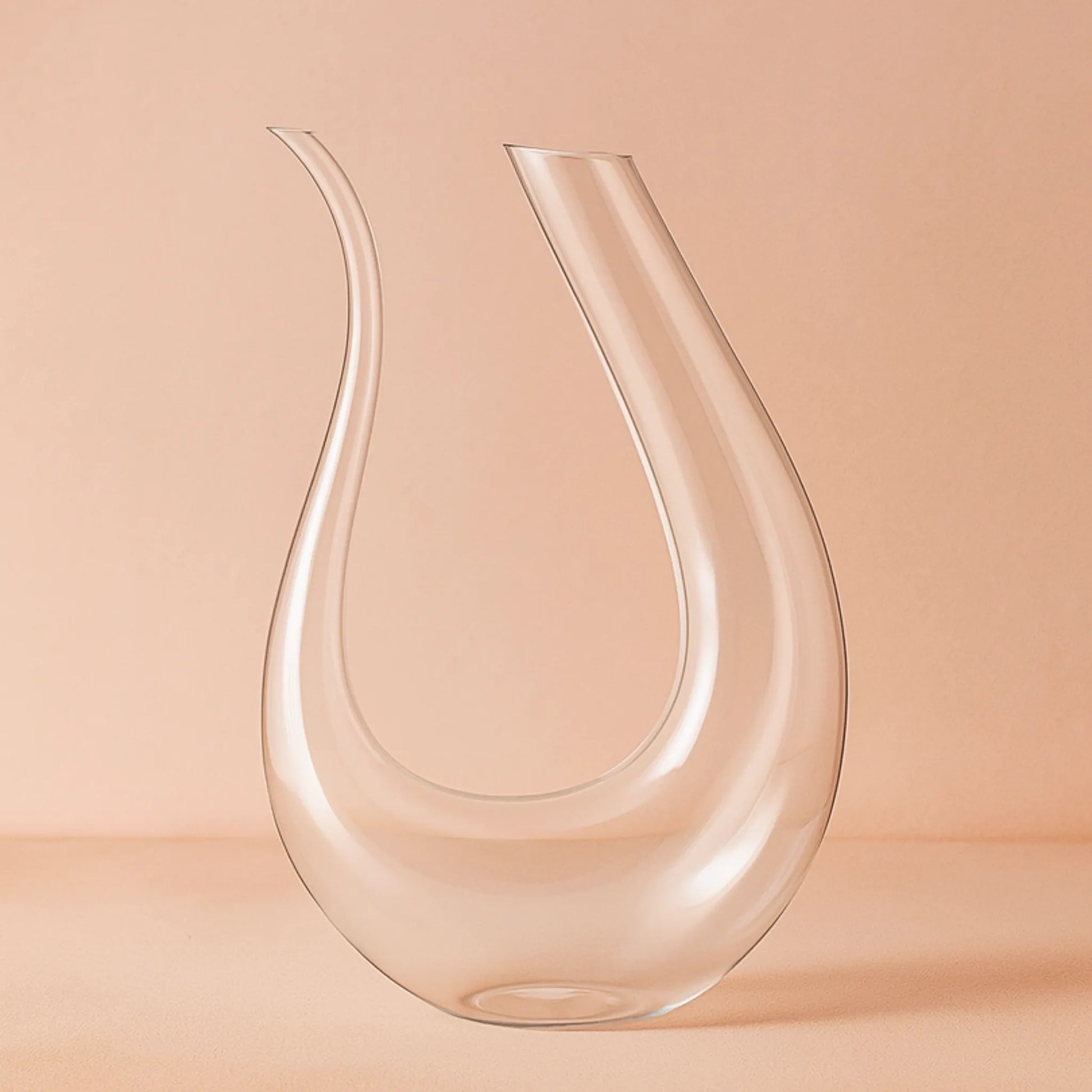 Clear glass carafe on a peach background