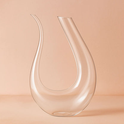 Clear glass carafe on a peach background